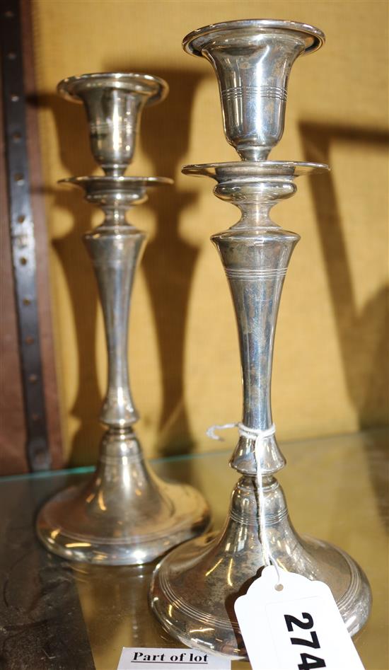 A pair of loaded silver candlesticks